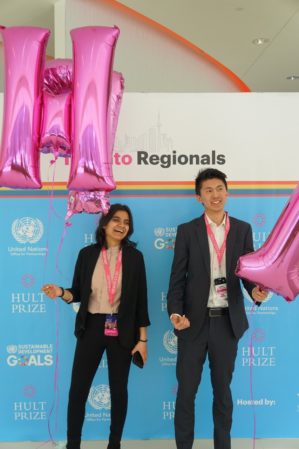 Photo of Adya Aggarwal and Eric Li holding balloons at the Hult Prize competition in Toronto